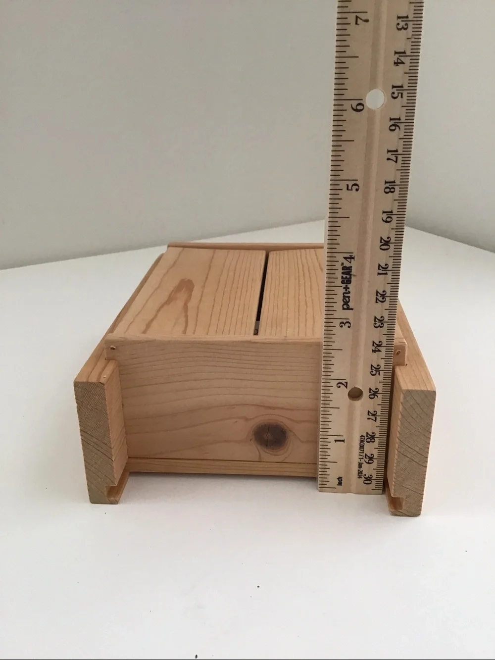 Handmade wooden cabinet holding a small wooden Nativity set